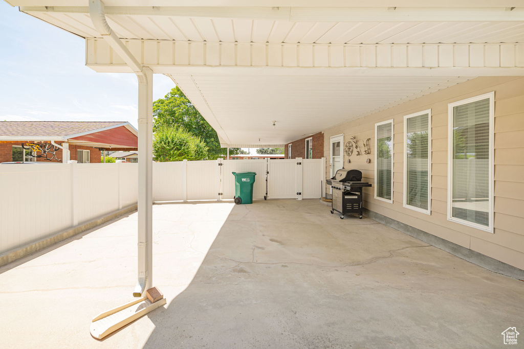 View of patio with a gate and grilling area