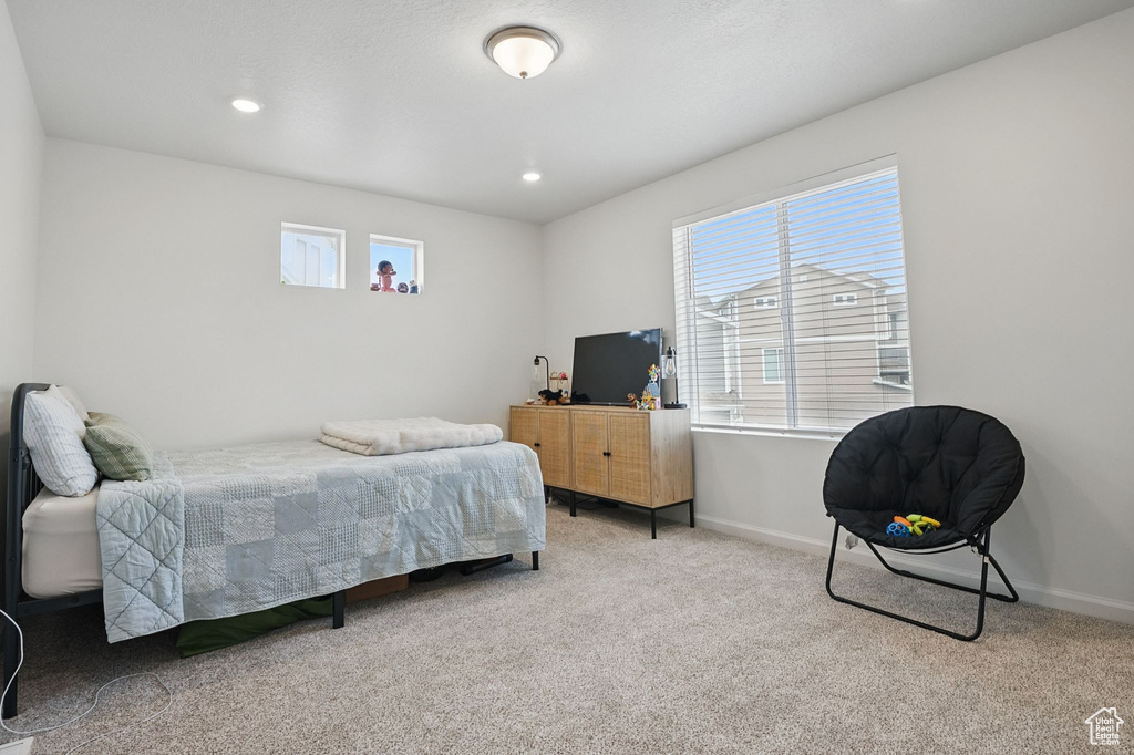 Bedroom with multiple windows, carpet floors, and recessed lighting