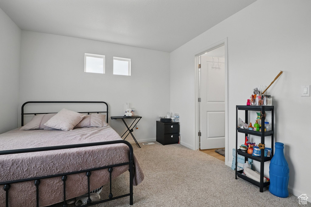 Bedroom featuring carpet floors and baseboards
