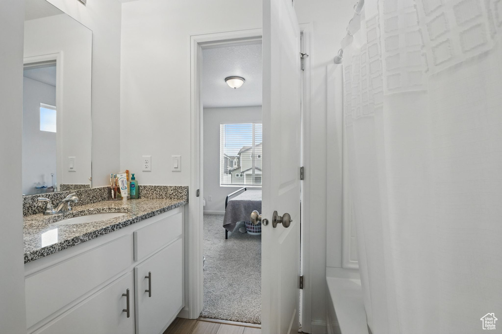 Ensuite bathroom with vanity and baseboards