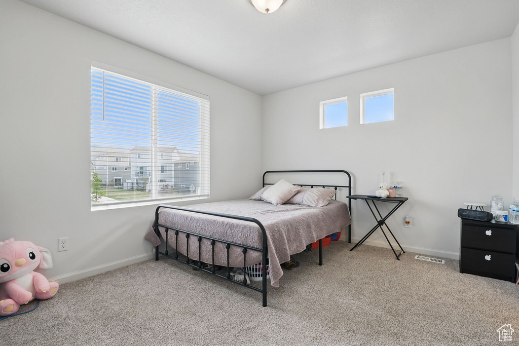 Bedroom with carpet flooring and baseboards