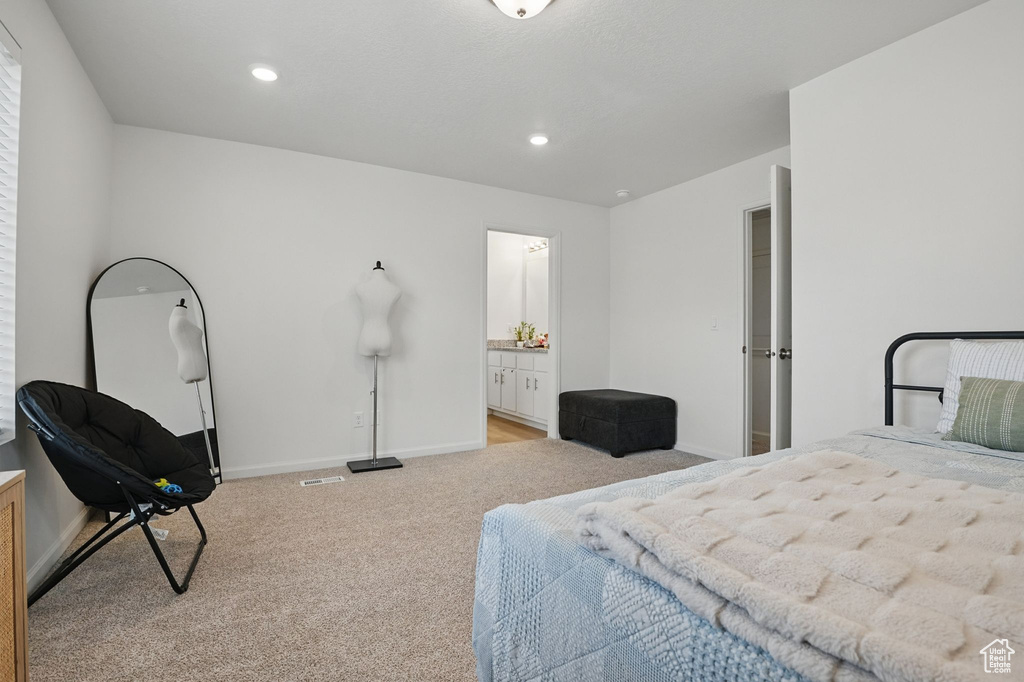 Bedroom with carpet floors, connected bathroom, and recessed lighting