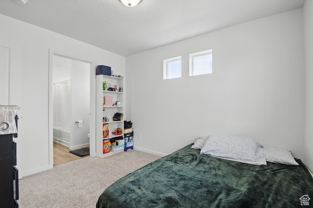 Bedroom with carpet floors and connected bathroom