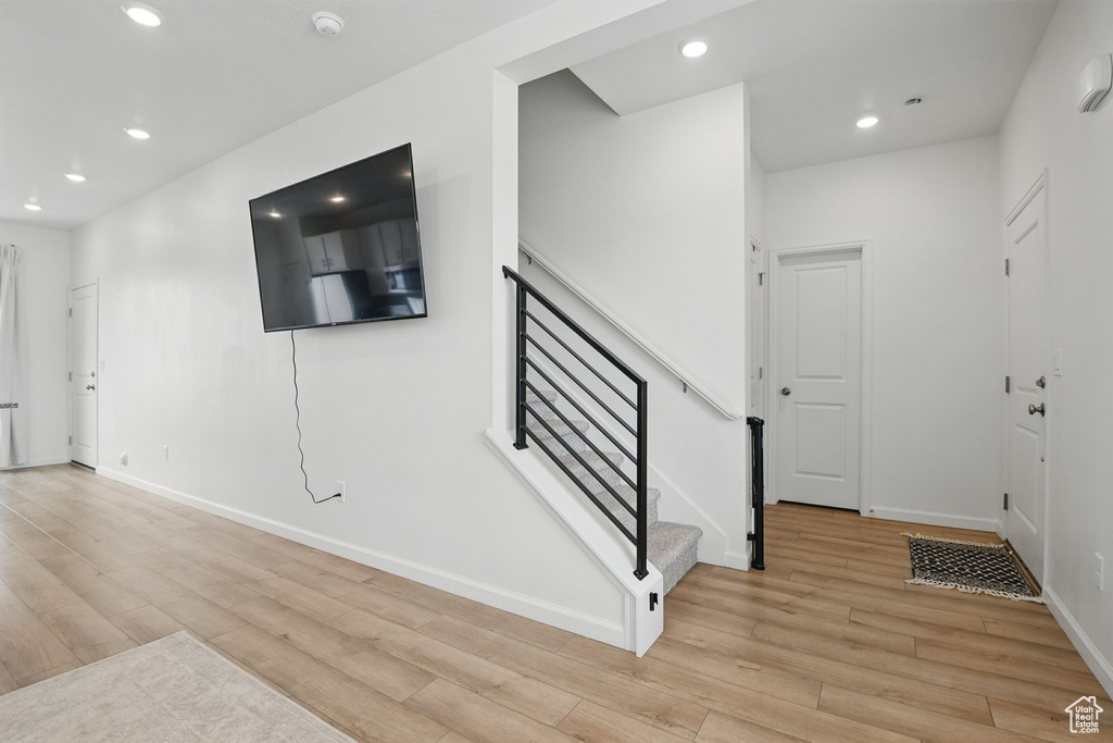 Entrance foyer featuring recessed lighting, light wood finished floors, and stairway