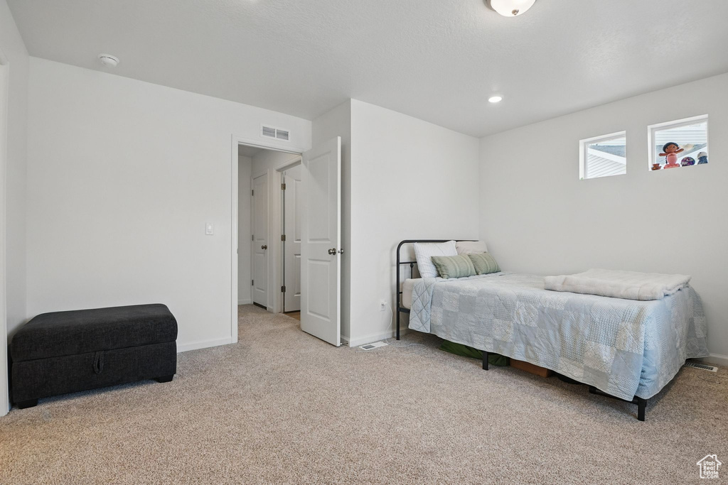 Bedroom featuring carpet flooring and baseboards