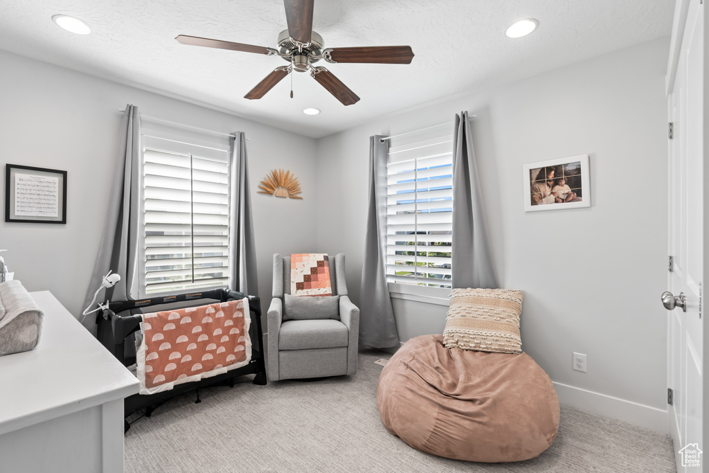 Living area featuring carpet flooring, recessed lighting, and a ceiling fan