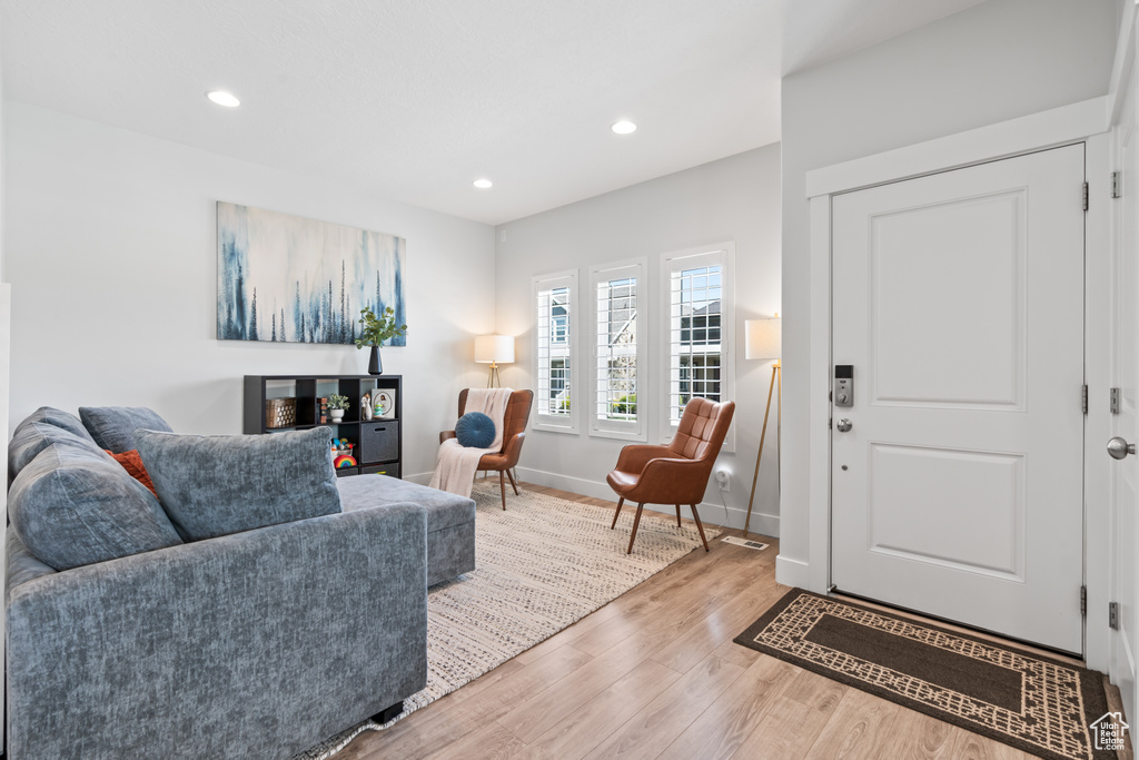 Living room featuring wood finished floors and recessed lighting