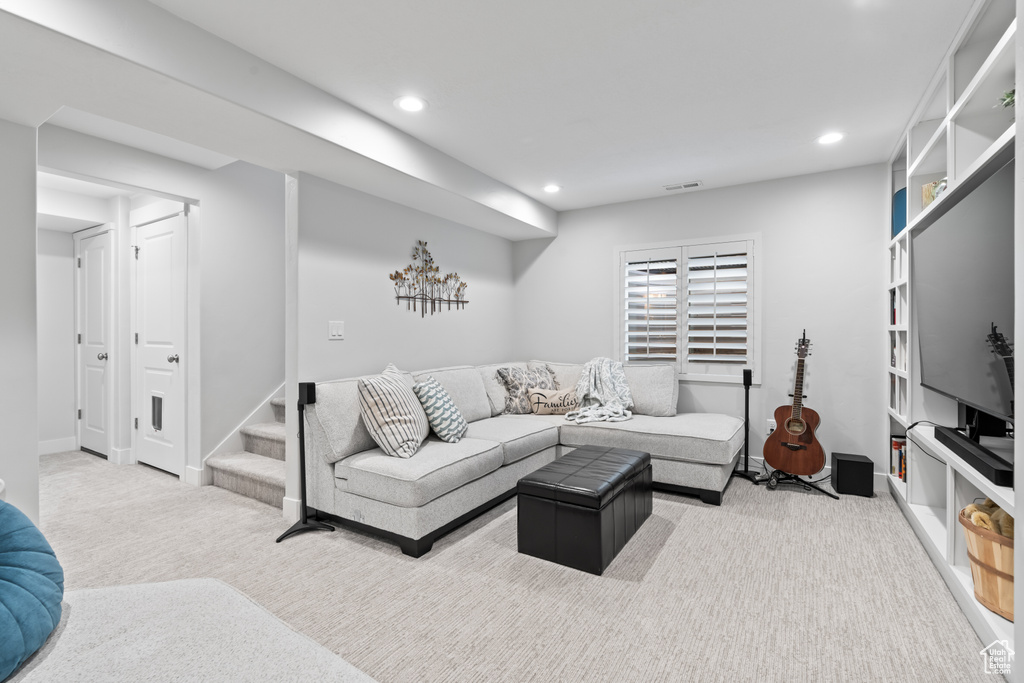Living room featuring recessed lighting, stairs, and carpet floors