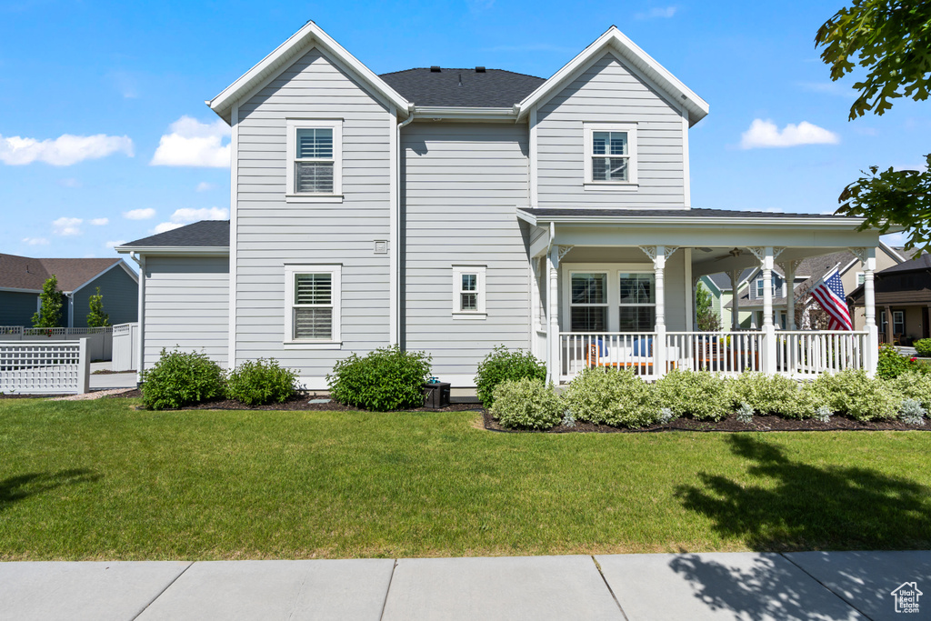 Rear view of property featuring a porch and a shingled roof