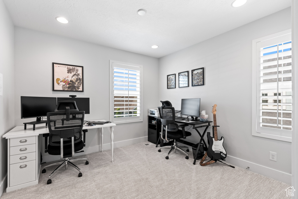 Office featuring light colored carpet and recessed lighting