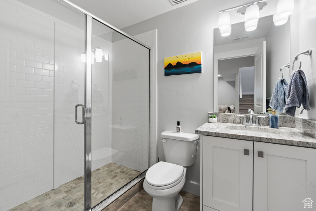 Full bathroom with vanity and a stall shower