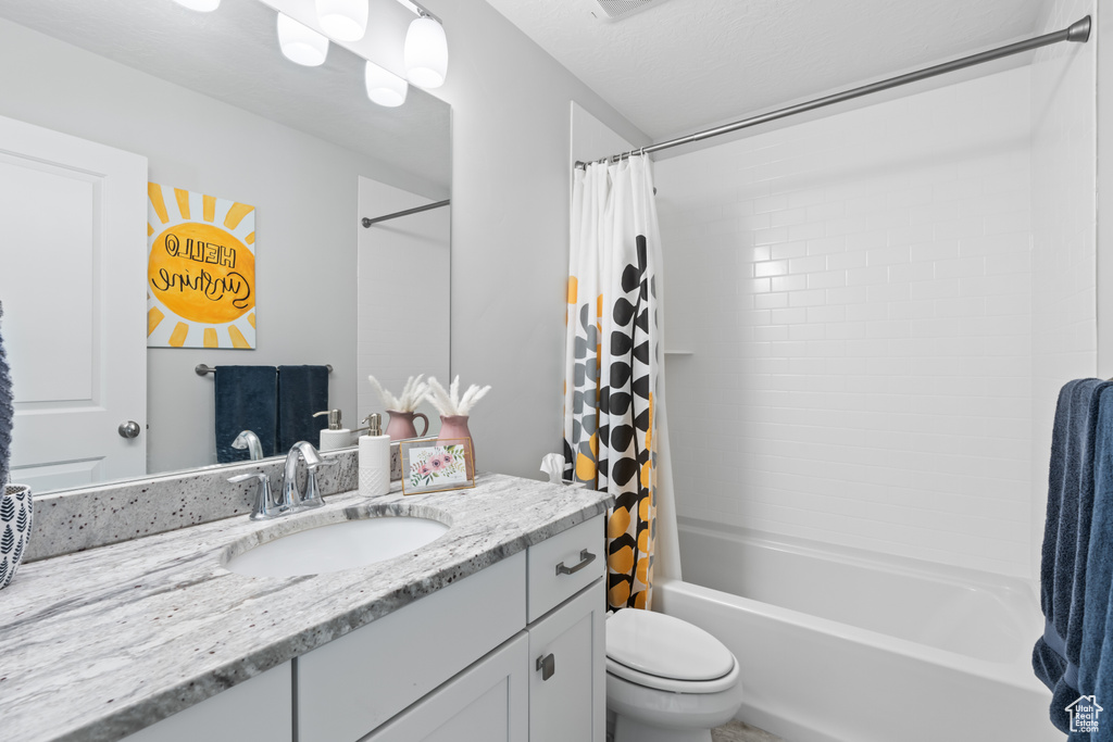 Full bathroom with vanity and shower / tub combo