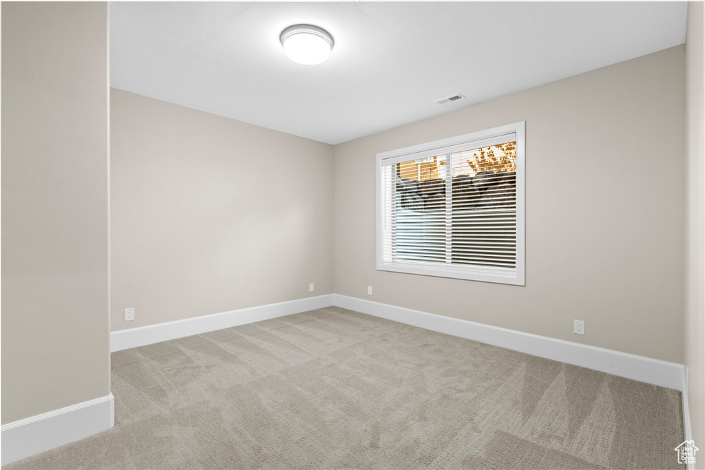 Unfurnished room featuring carpet flooring and baseboards