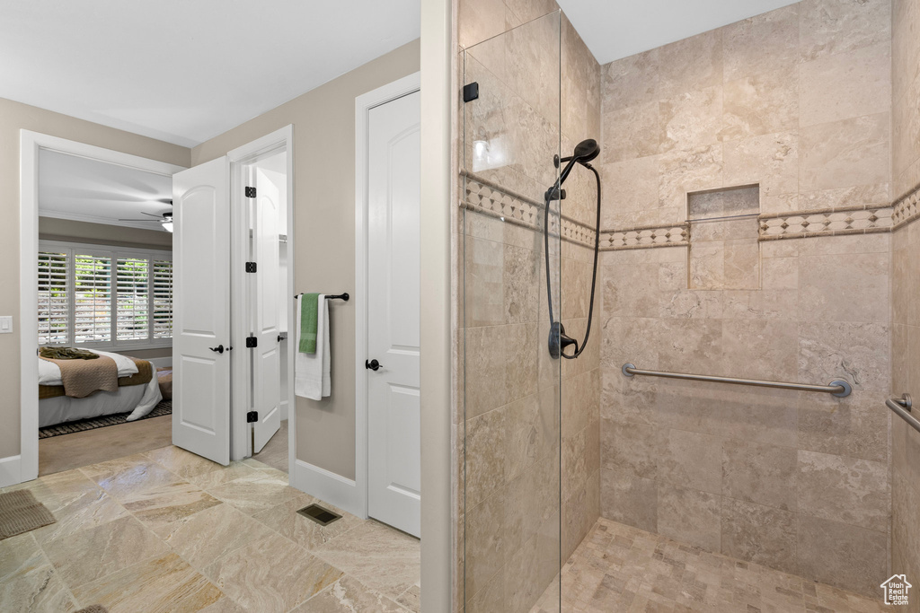 Ensuite bathroom with a shower stall and ceiling fan