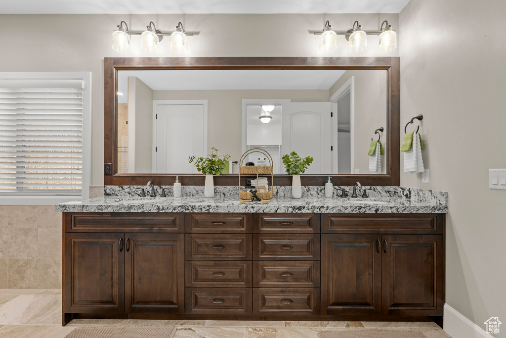 Full bath featuring double vanity