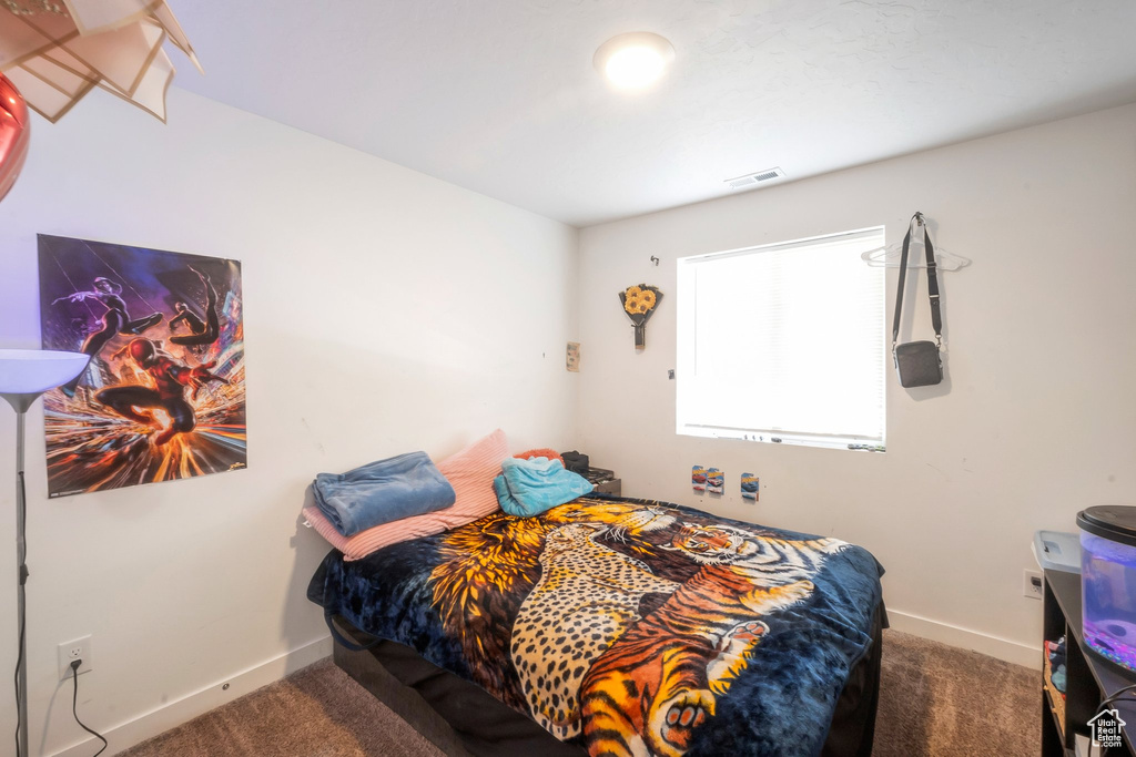 Bedroom with carpet floors and baseboards