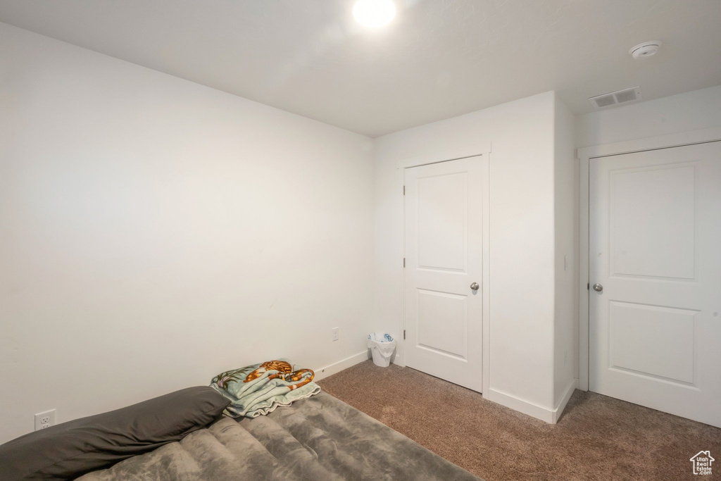 Unfurnished bedroom with carpet floors and baseboards