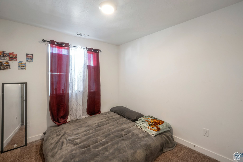 Bedroom with carpet flooring and baseboards