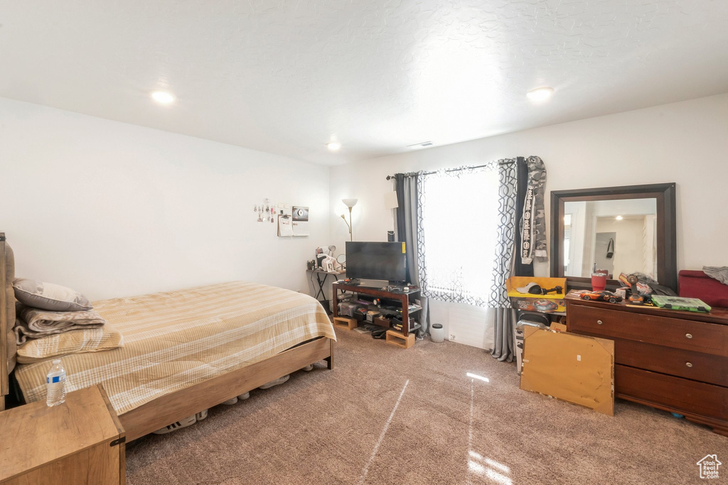 Bedroom with light carpet and recessed lighting