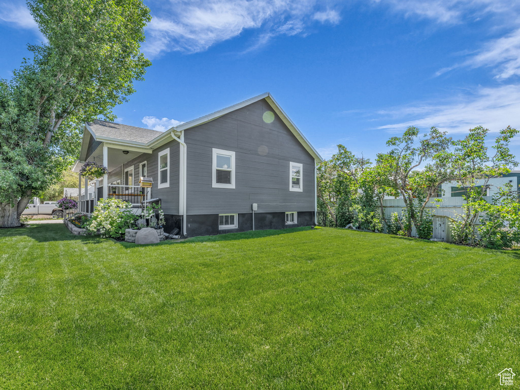 Rear view of property featuring covered porch