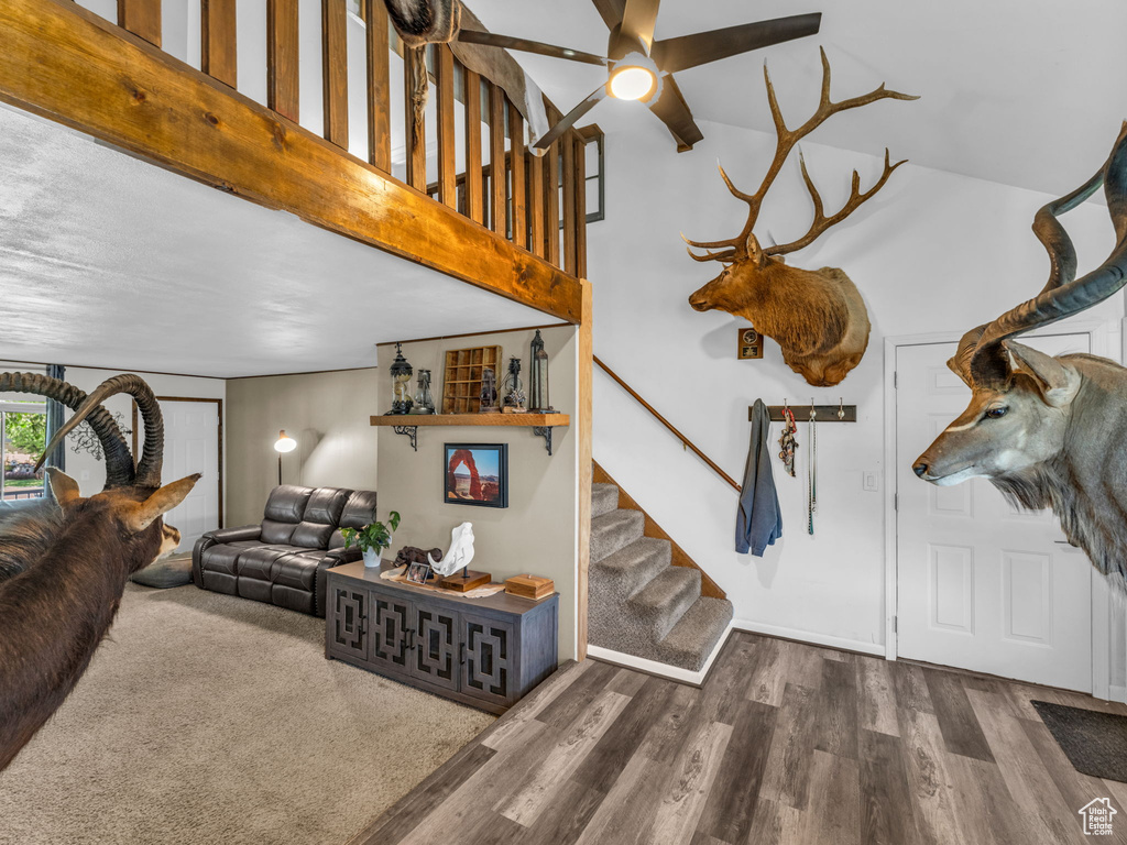Living room featuring stairway, wood finished floors, and a ceiling fan