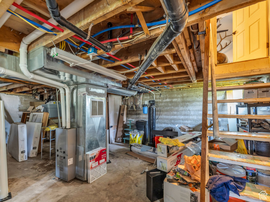 Unfinished basement featuring heating unit