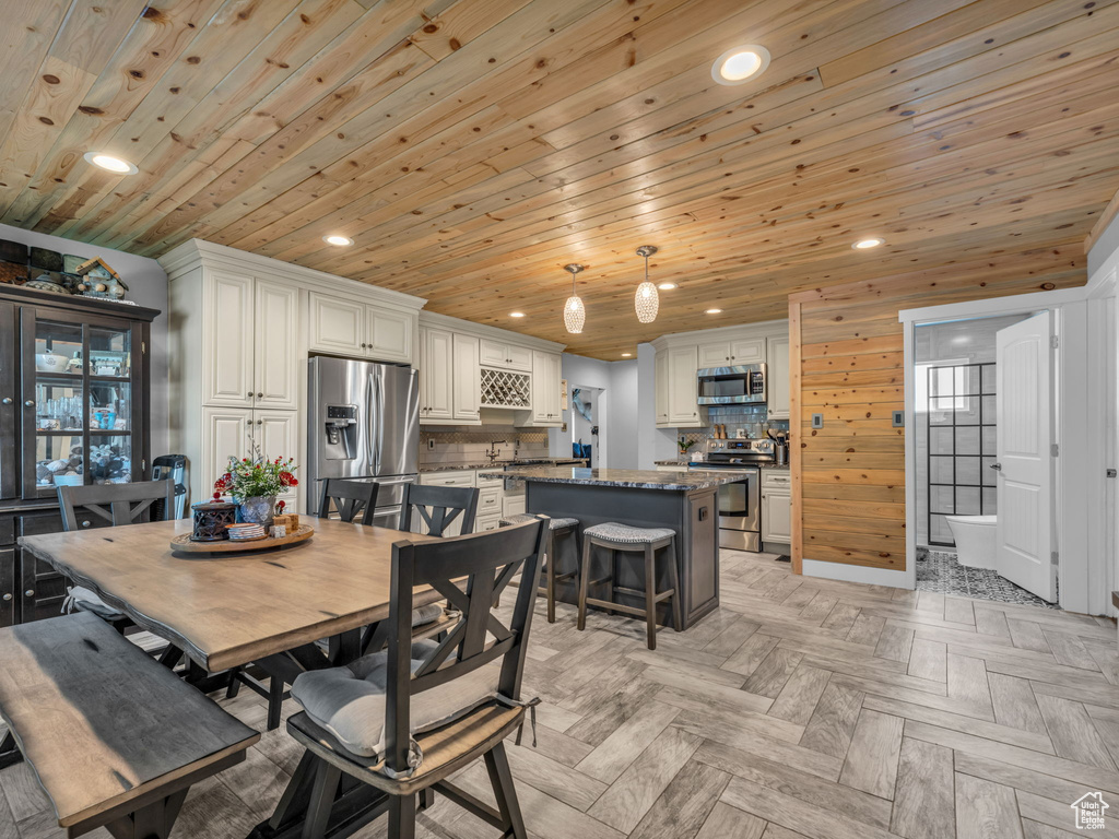 Dining area with recessed lighting and wood ceiling