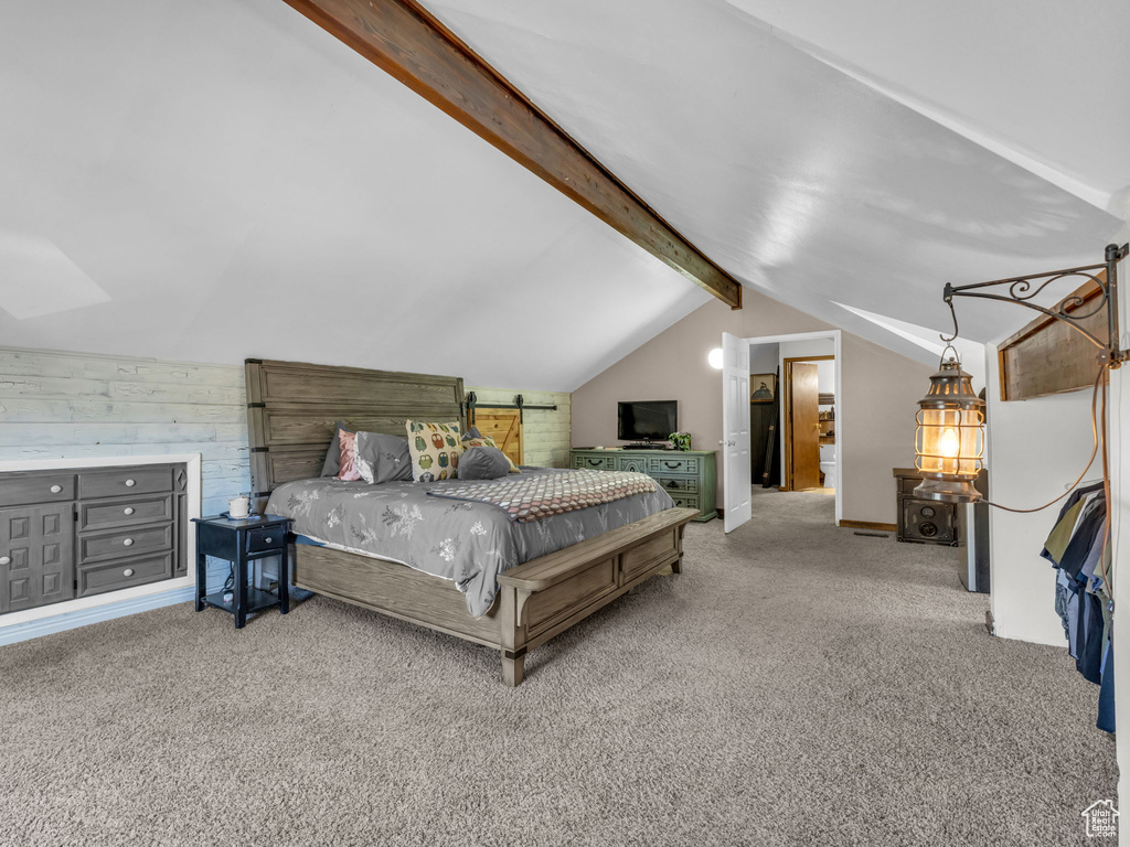 Bedroom featuring carpet floors and wooden walls