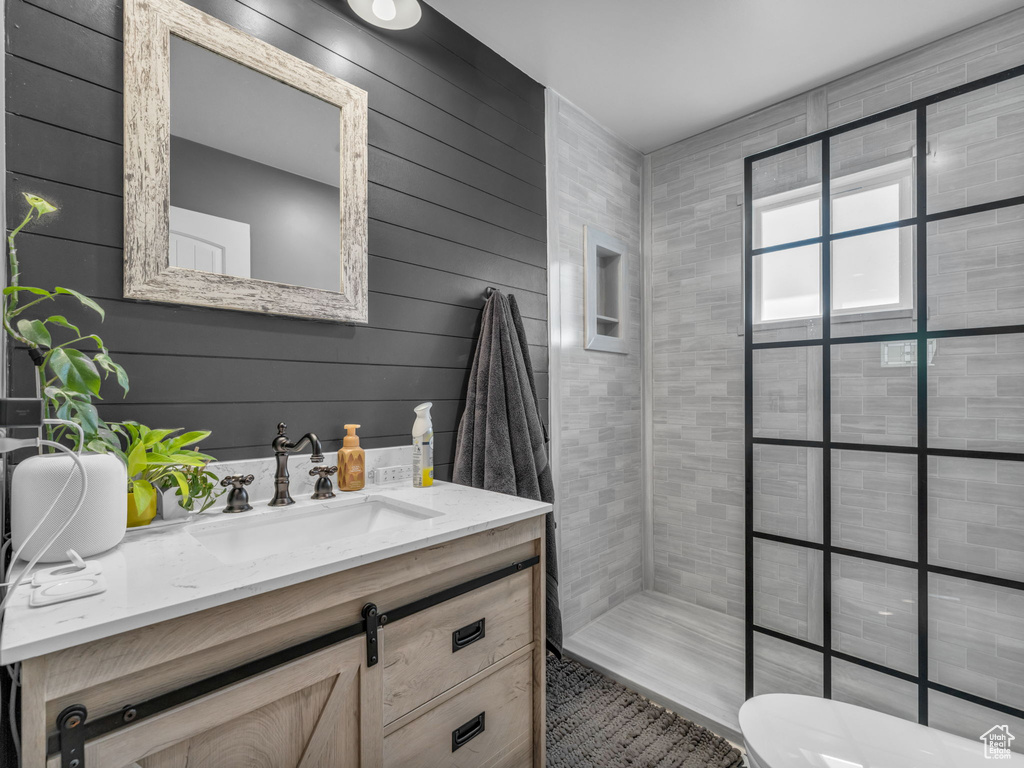 Bathroom with vanity and a tile shower