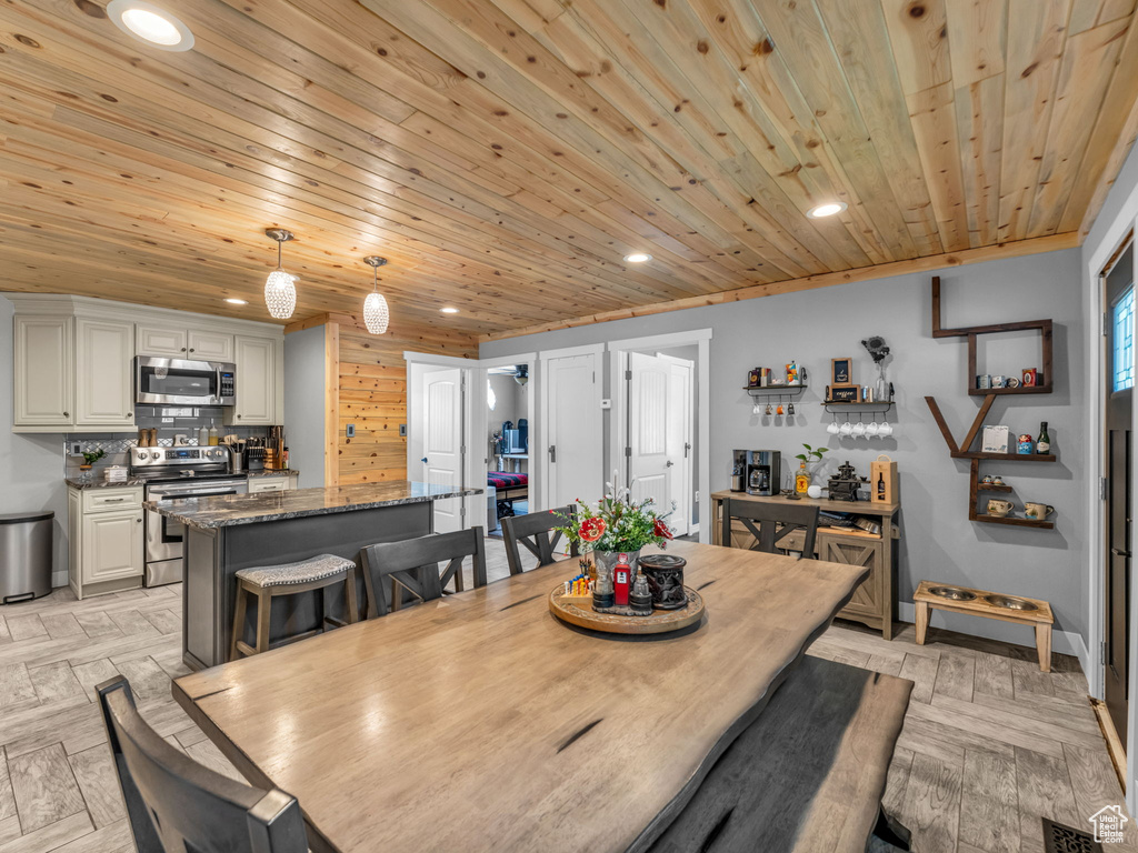 Dining room with recessed lighting and wood ceiling