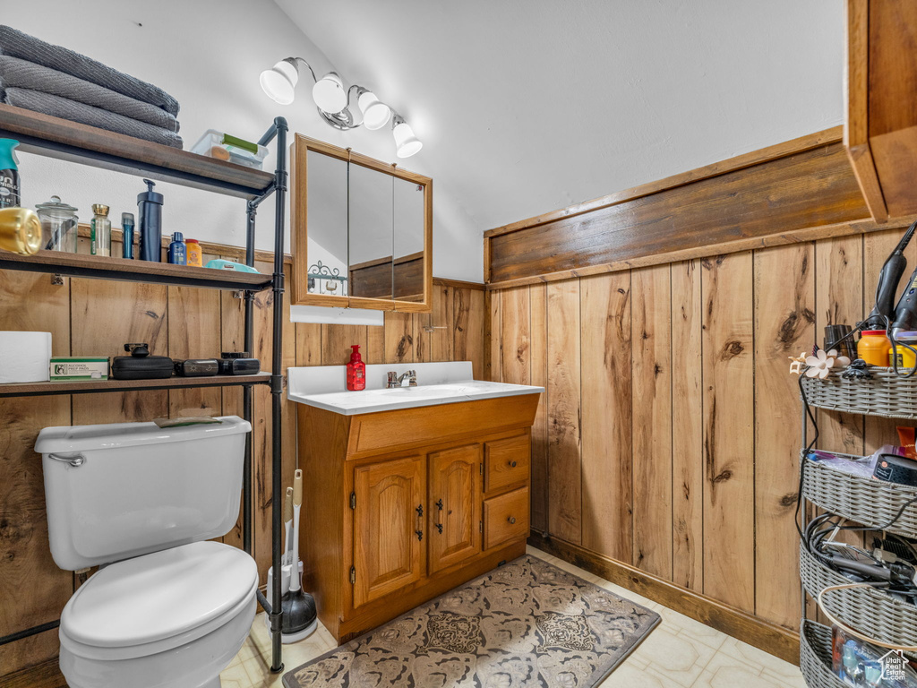 Bathroom with vanity and wooden walls