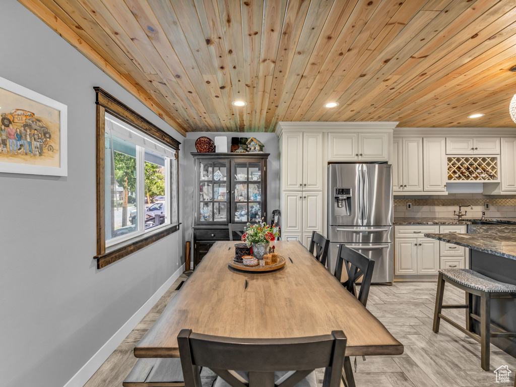 Dining room with wooden ceiling, recessed lighting, and light wood-type flooring