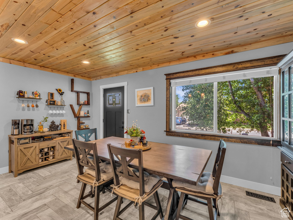 Dining area with healthy amount of natural light, recessed lighting, and wooden ceiling