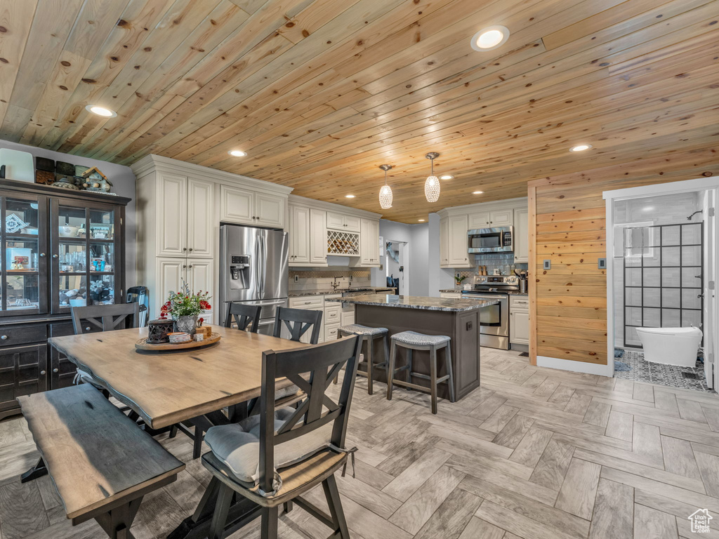 Dining area featuring recessed lighting and wooden ceiling