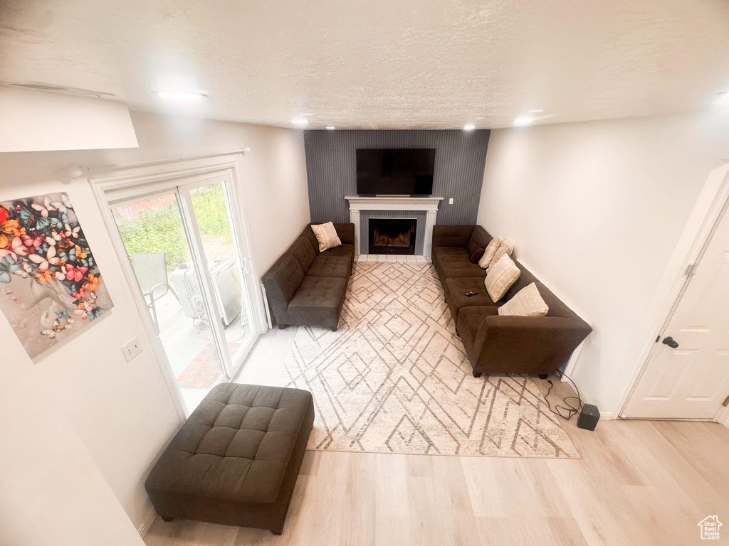 Unfurnished living room with wood finished floors and a fireplace