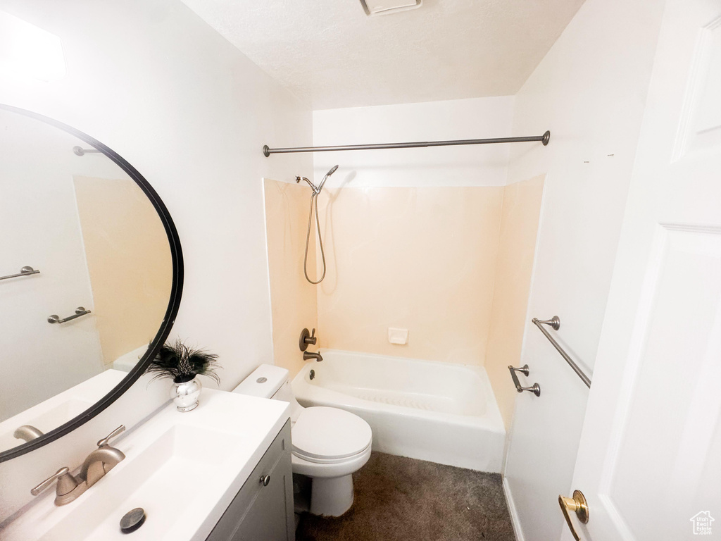 Bathroom featuring vanity and washtub / shower combination