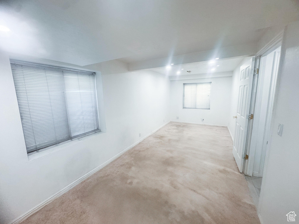 Carpeted empty room with baseboards
