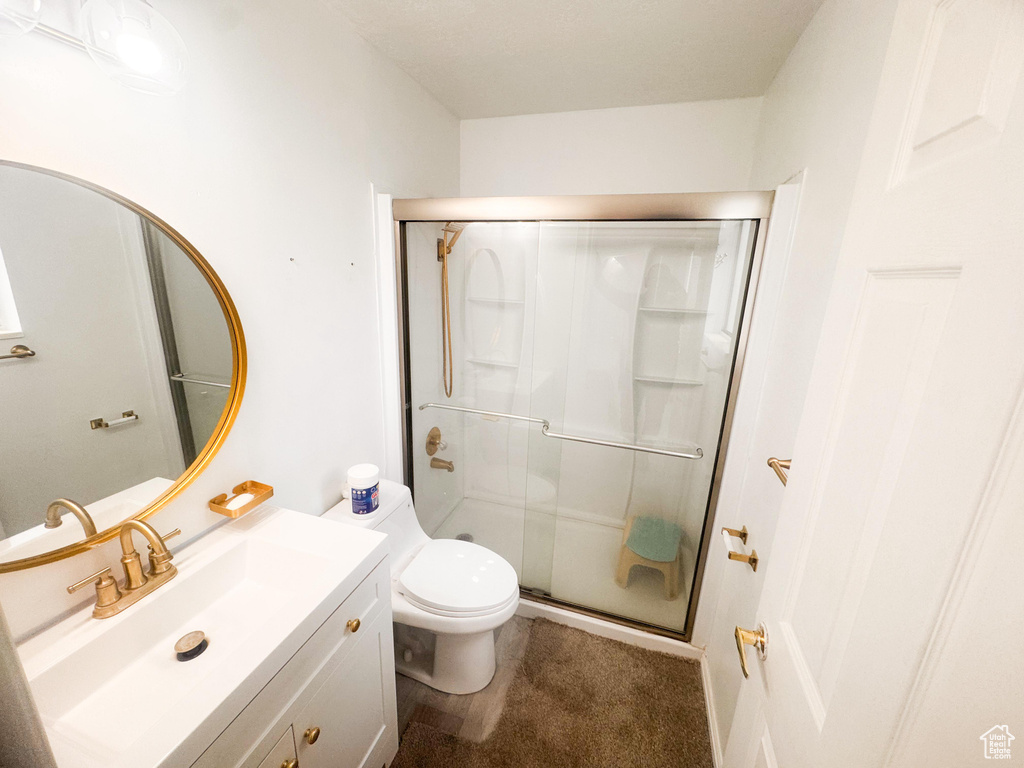 Bathroom with a stall shower and vanity
