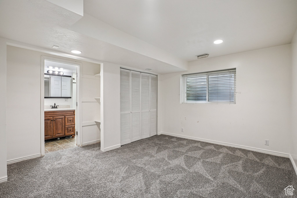 Unfurnished bedroom with carpet, recessed lighting, a closet, and ensuite bath