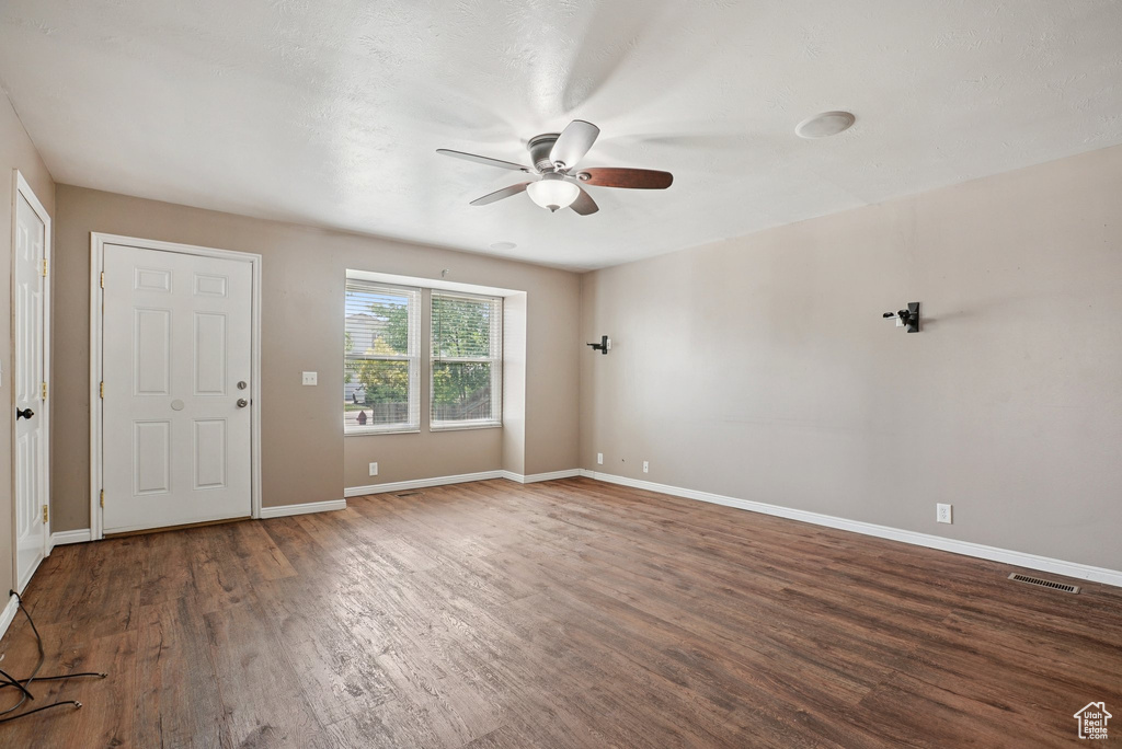 Spare room featuring a ceiling fan and wood finished floors