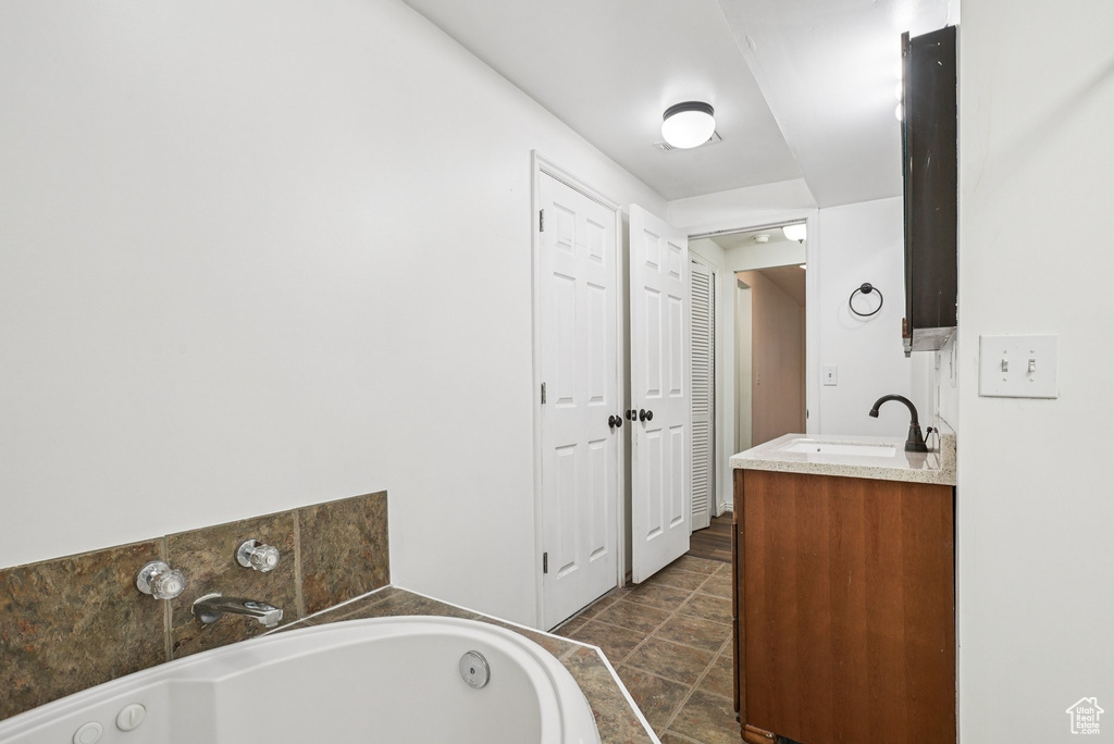 Bathroom featuring vanity and a jetted tub