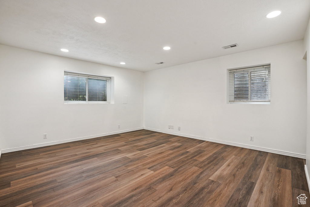 Spare room with recessed lighting and dark wood-type flooring