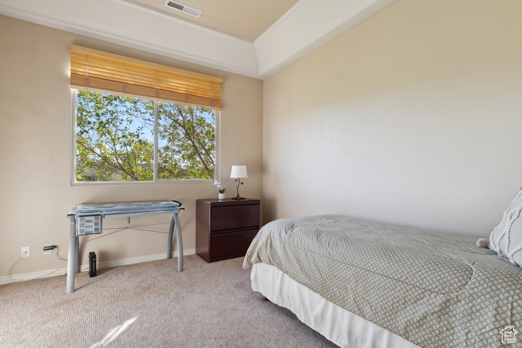 Bedroom featuring carpet and baseboards