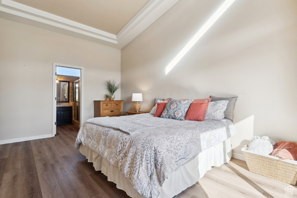 Bedroom featuring wood finished floors and baseboards