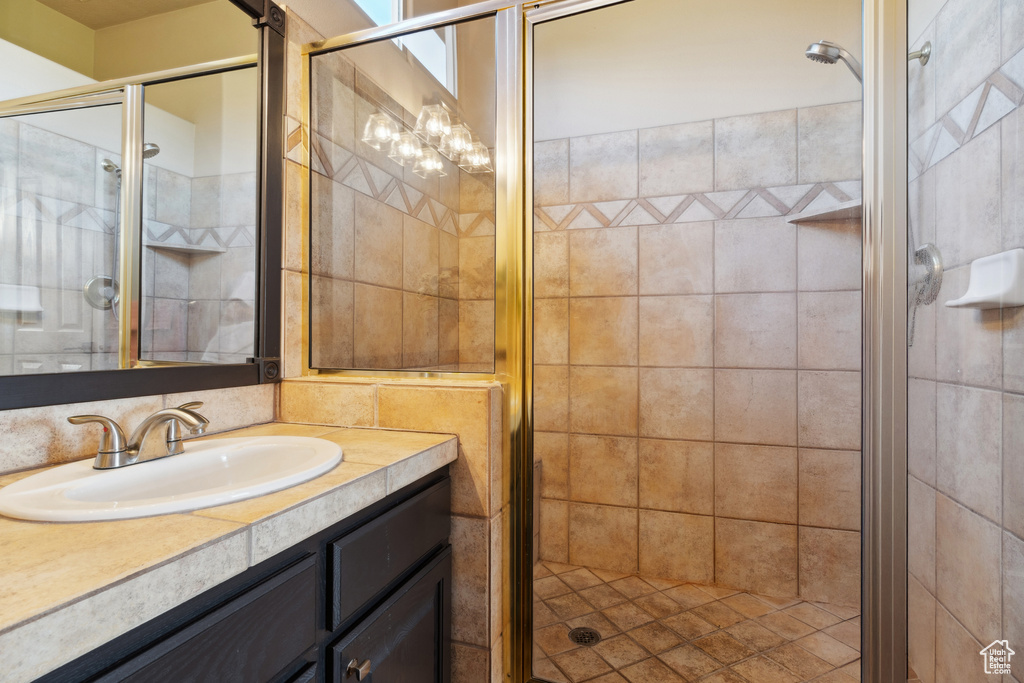 Full bath featuring vanity and a stall shower