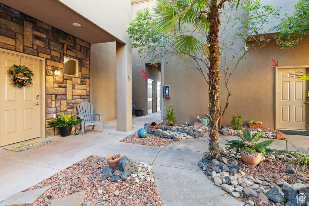 Entrance to property featuring stucco siding and stone siding