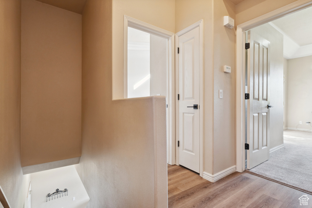 Corridor with wood finished floors and baseboards
