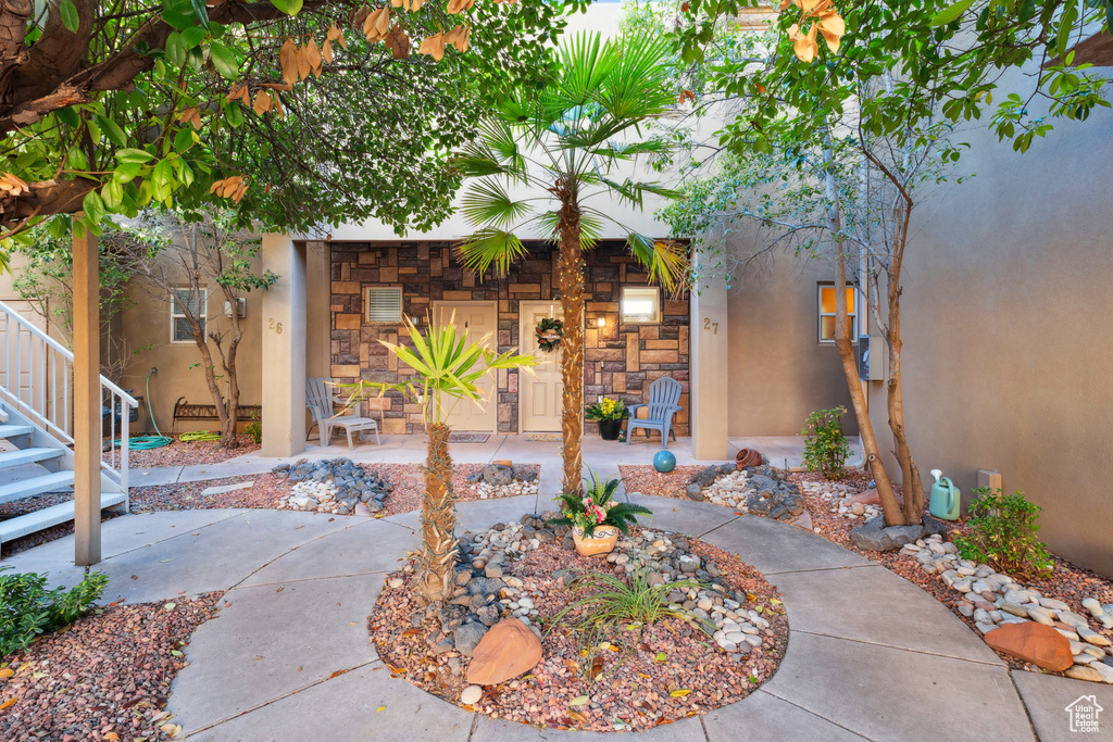 View of exterior entry featuring stucco siding and stone siding