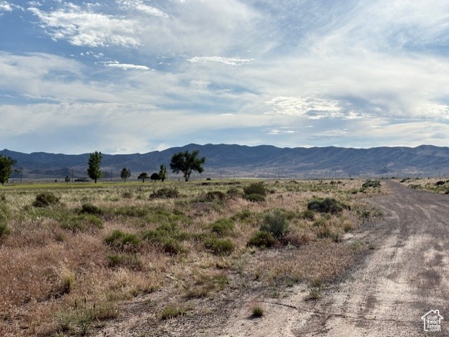 View of mountain backdrop with rural landscape
