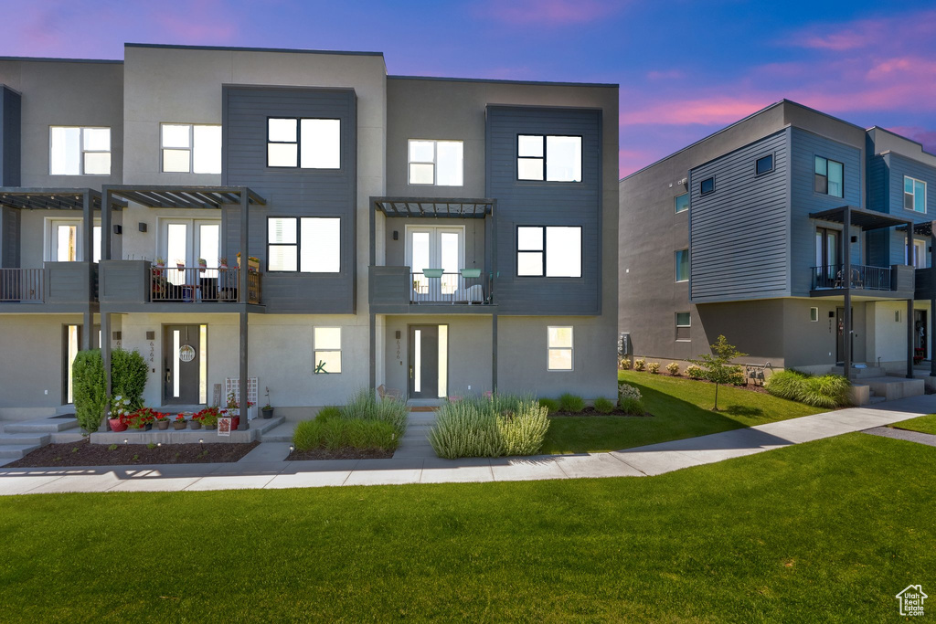 View of property at dusk